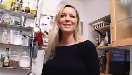 Outstanding German MILF with huge boobs dildoing her shaved muff in the kitchen